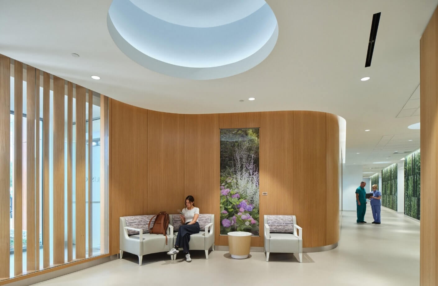 Modern hospital waiting area with wooden decor and seating, featuring a serene atmosphere.