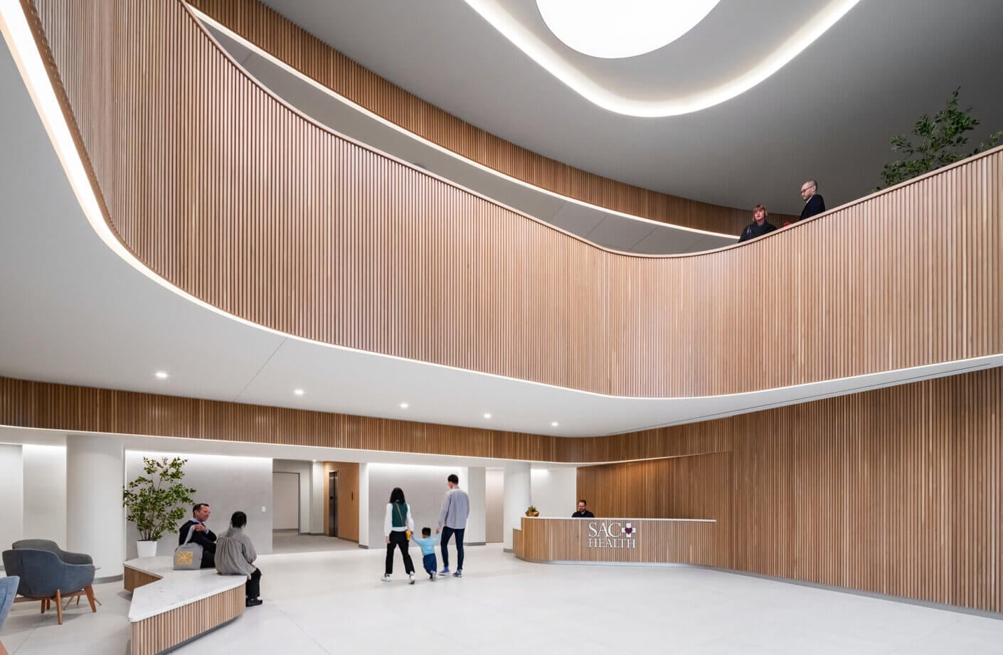 Modern healthcare lobby with wooden accents and curved design.