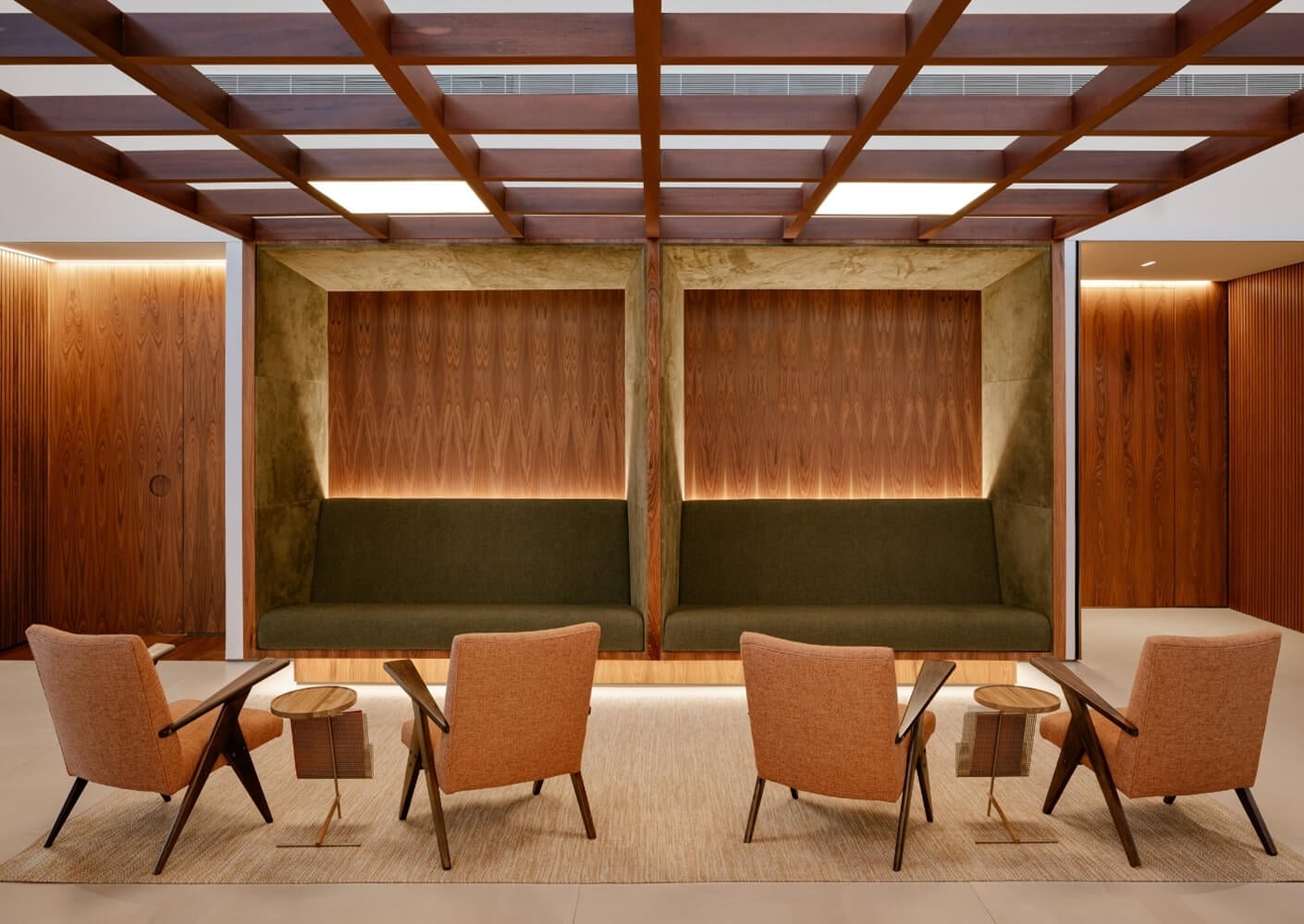 Modern office lounge with mid-century chairs and wooden accents.