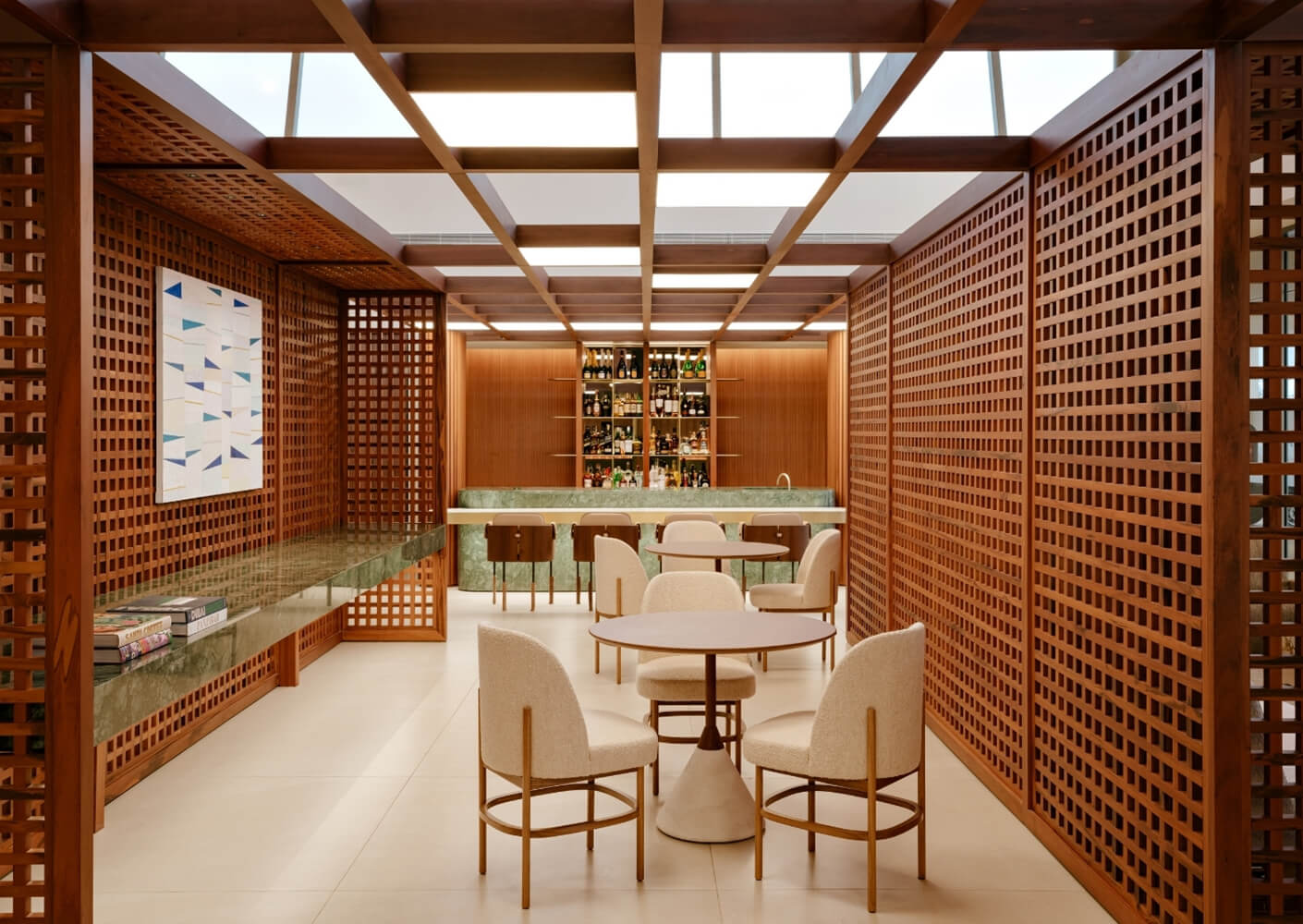 Contemporary lounge with wooden lattice walls, dining table, and bar seating.