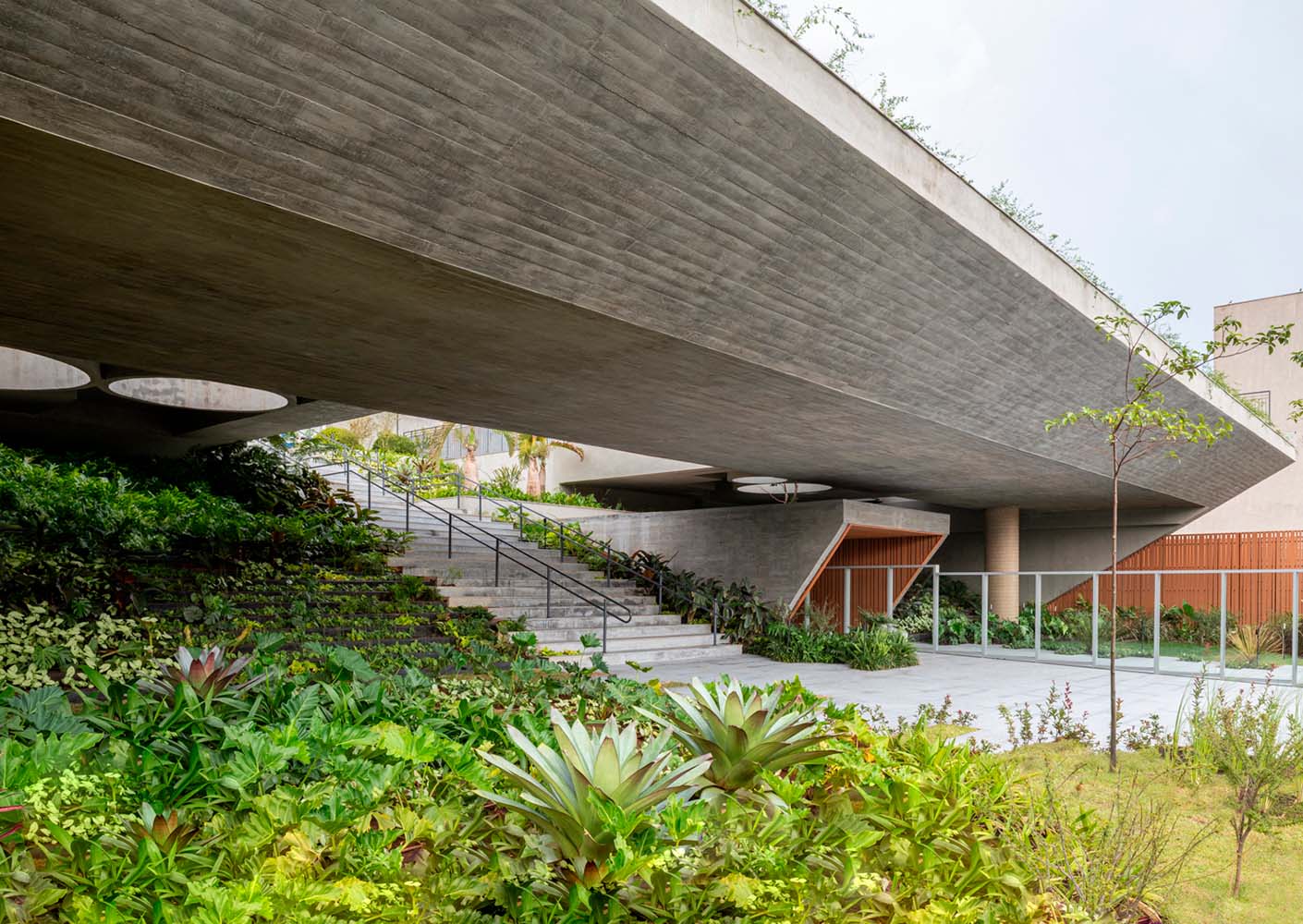 Modern building with lush garden integration and sleek architecture.