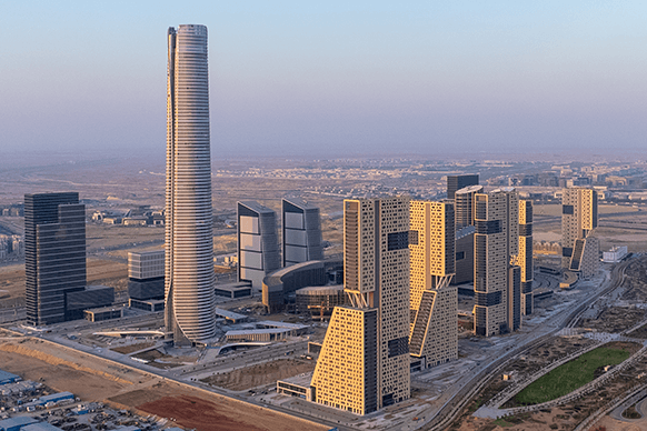 Futuristic skyscrapers and modern buildings in a cityscape at dusk.