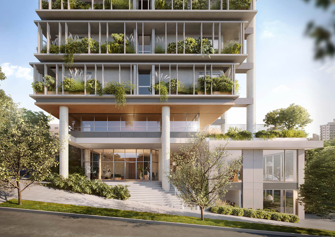 Modern building facade with lush green balconies and large glass windows.