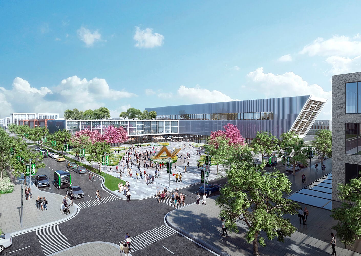 Modern campus plaza with trees, people, and buildings under a bright blue sky.