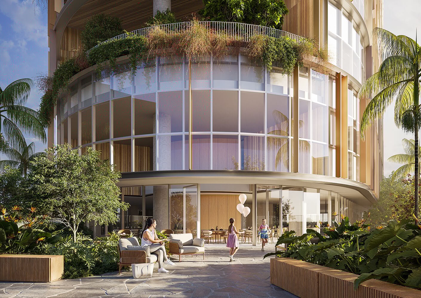 Modern building facade with lush greenery and outdoor seating area.