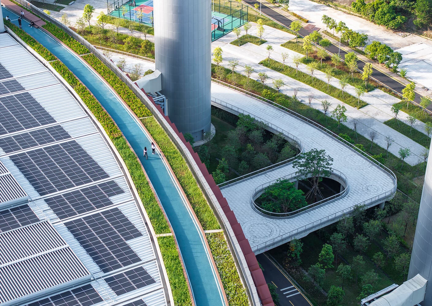 Rooftop garden with solar panels and pathway in urban park setting.