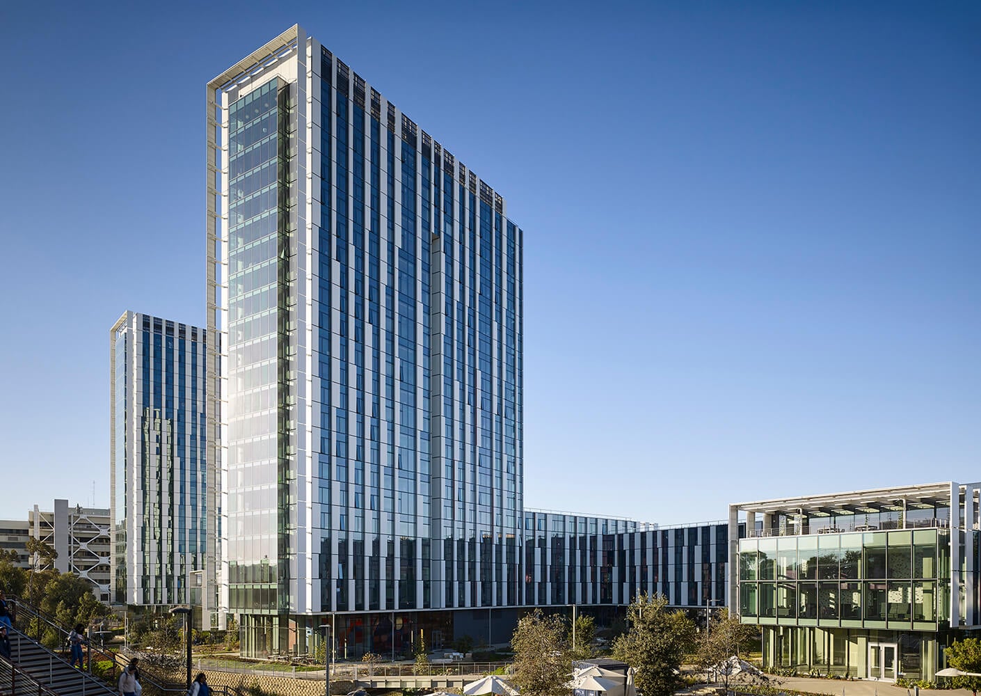 Modern glass office towers under a clear blue sky.