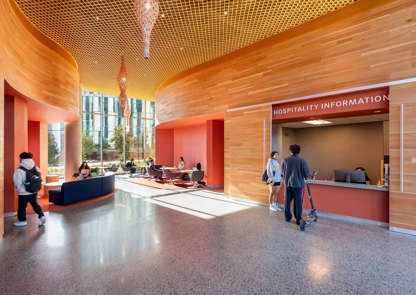 Modern lobby with wooden accents and hospitality information desk.