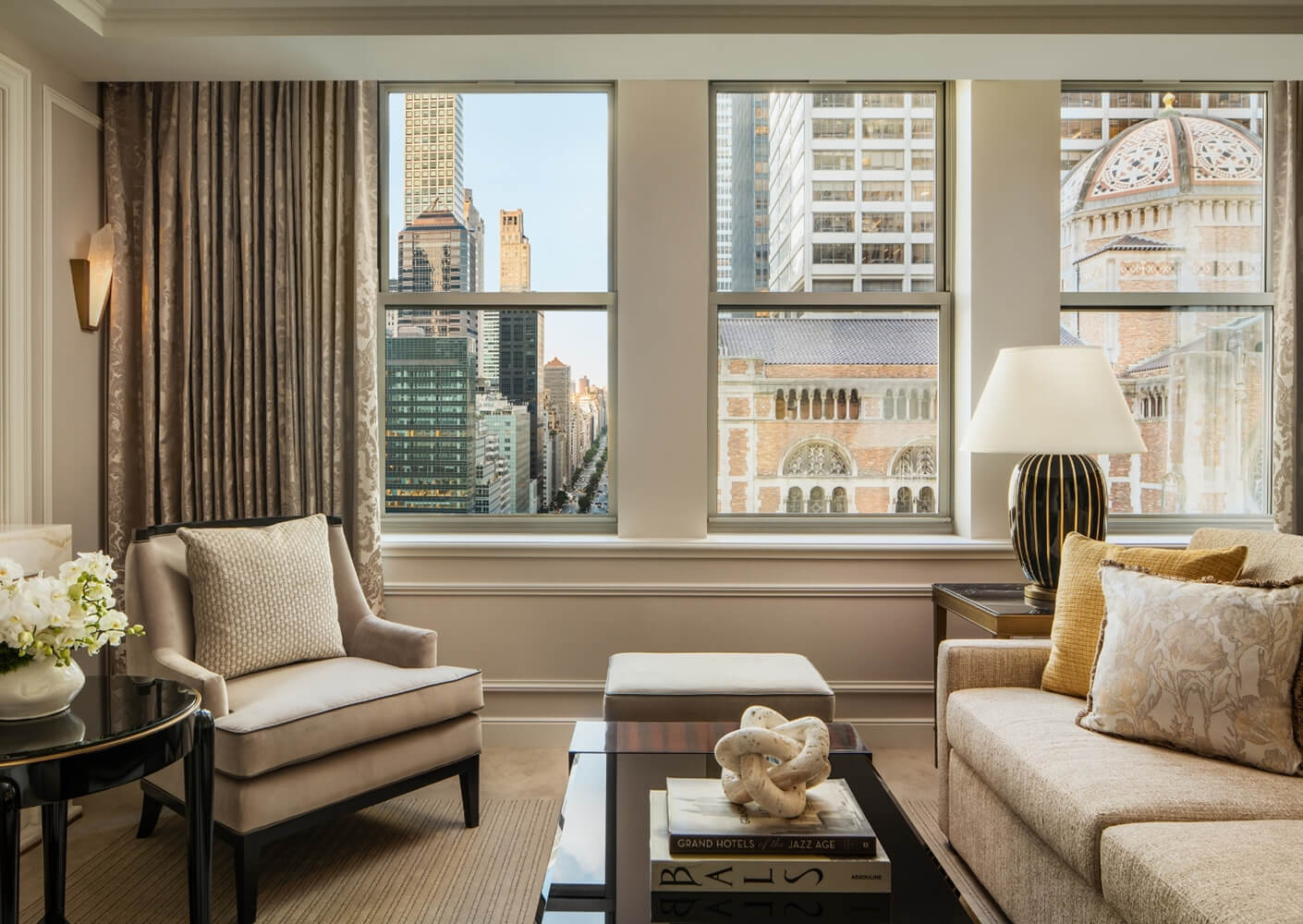 Elegant living room with cityscape view through large windows.