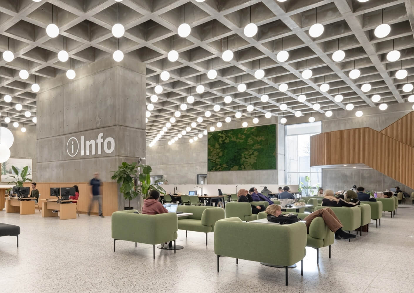 Modern public space with green seating and info desk.