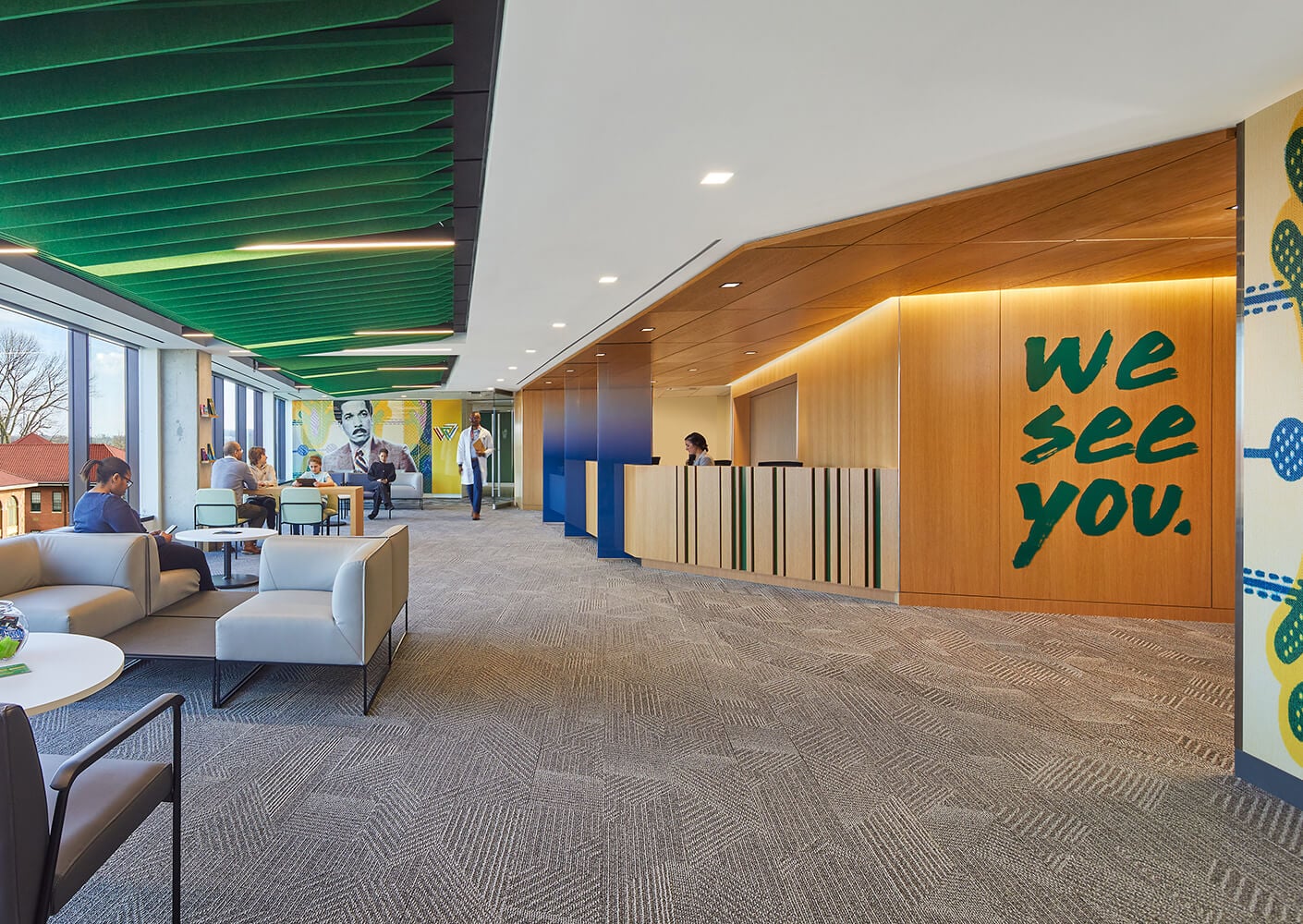 Modern office lobby with seating, art, and a welcoming reception desk.