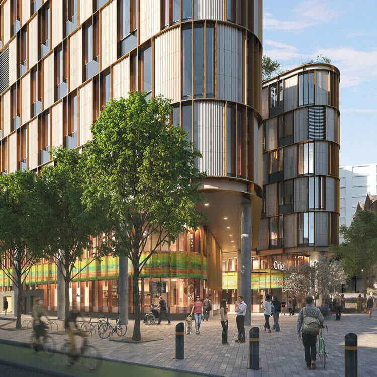 Modern lab building with glass facade, people and bicycles in foreground. A sign says 