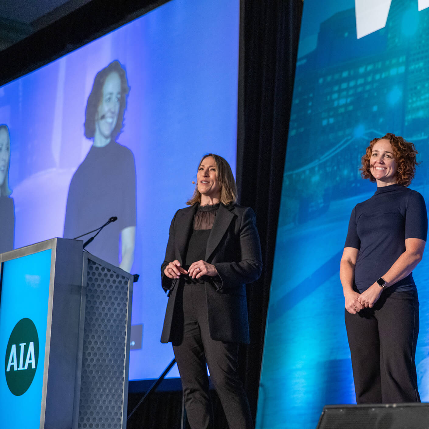 Yanel de Angel presenting at an AIA conference on stage.