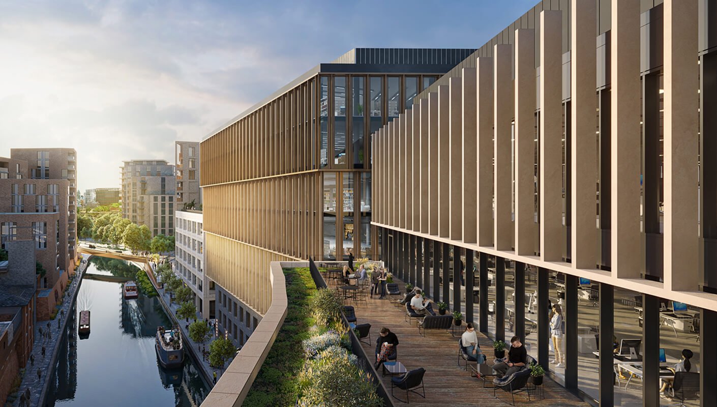 Modern office terrace overlooking city canal and buildings at sunset.