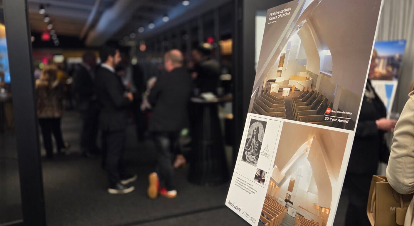 Architectural award event with attendees and church design board.