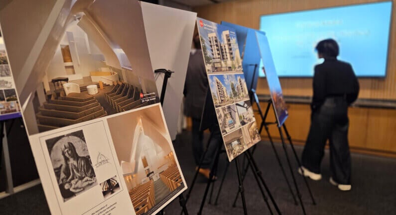 Architectural presentation with design posters on easels at an exhibit.