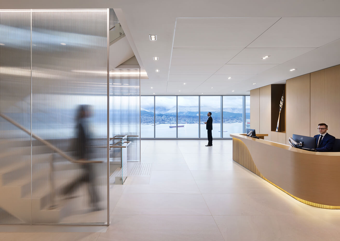 Modern office lobby with panoramic city and ocean view.