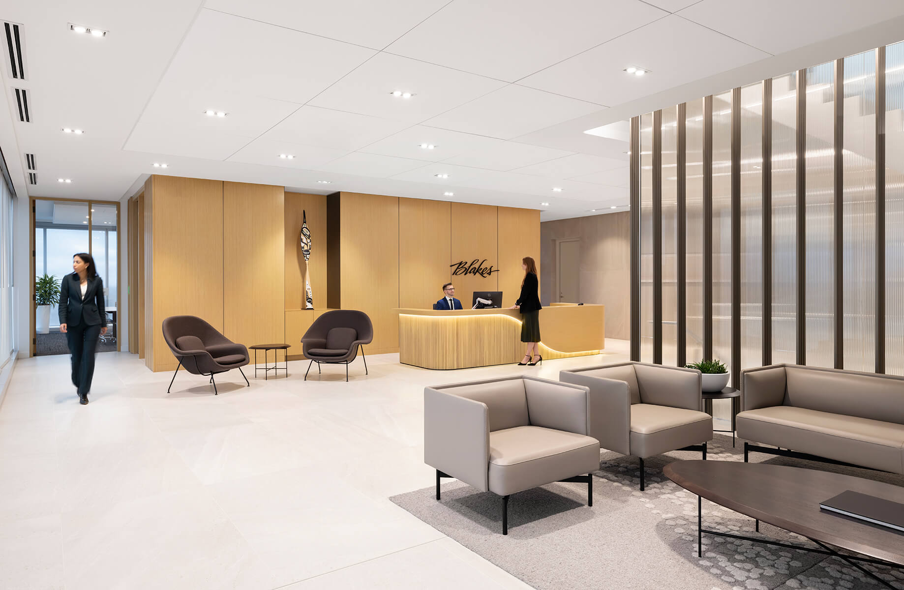 Modern office lobby with reception desk and seating area.