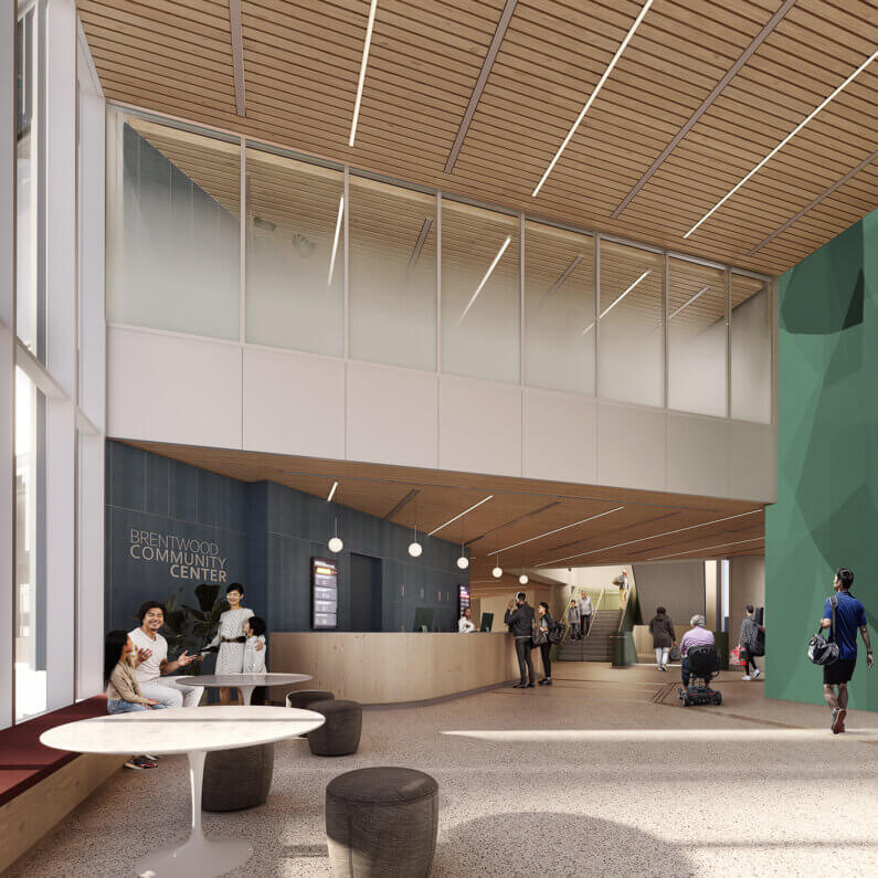 Modern community center lobby with people socializing and seeking information.