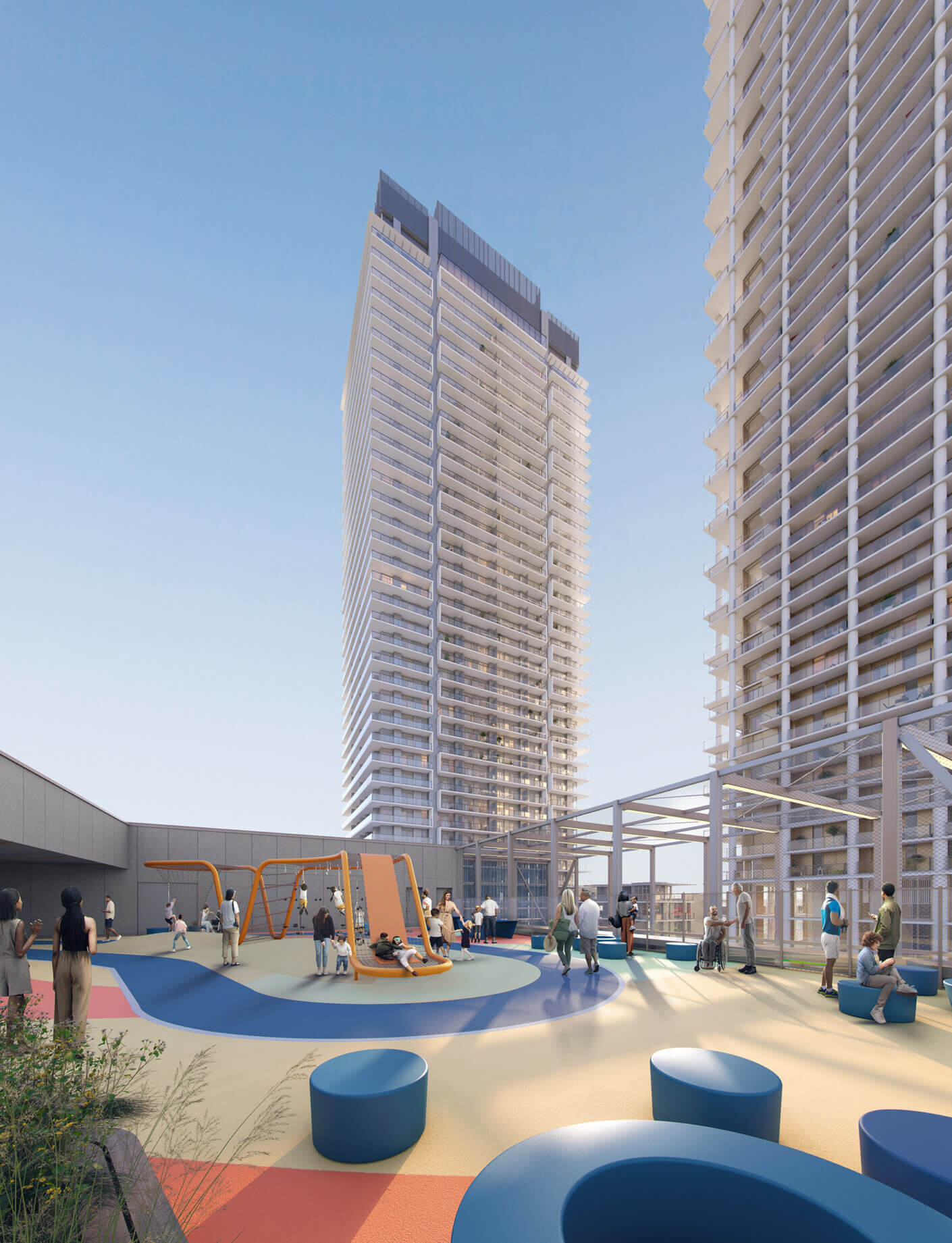Rooftop playground with slides, surrounded by modern high-rise buildings under a clear sky.