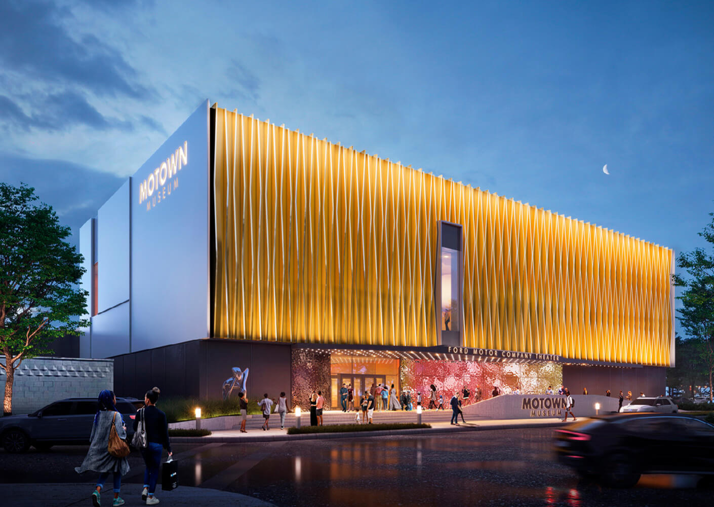 Modern Motown Museum building exterior illuminated at night with people outside.