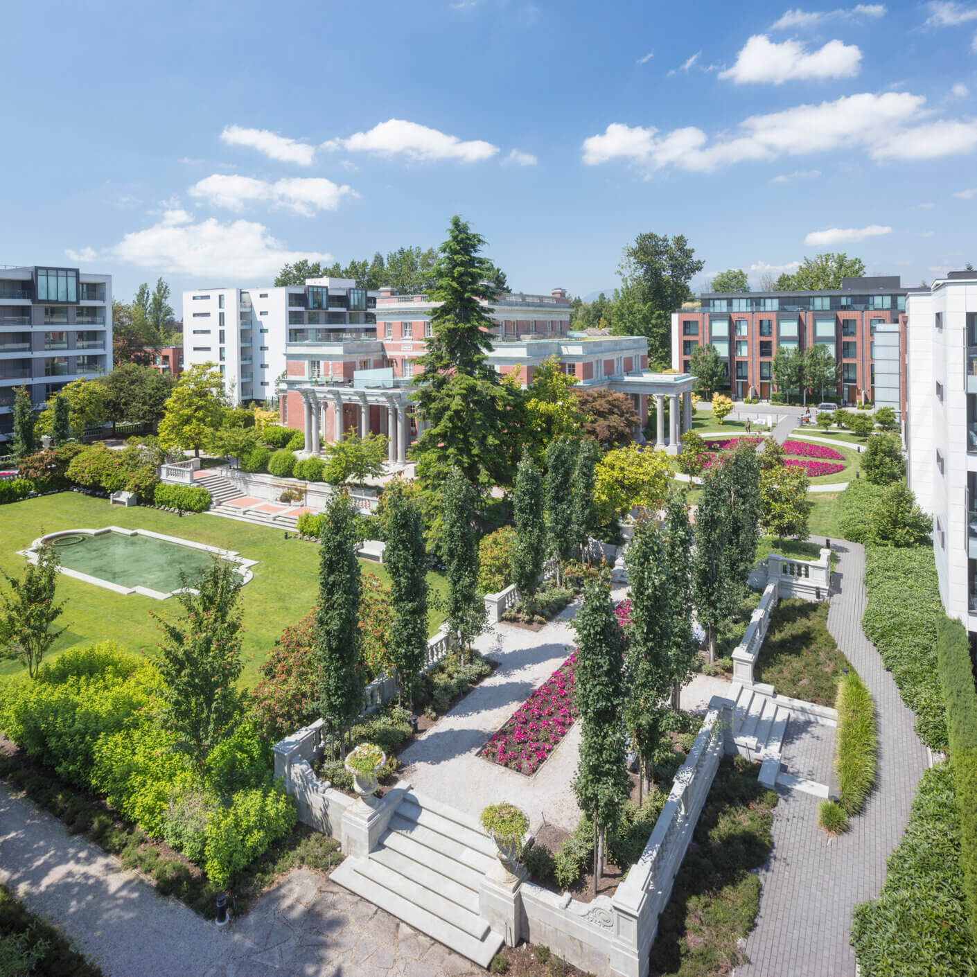 Modern urban garden with lush greenery and contemporary architecture under a sunny sky.