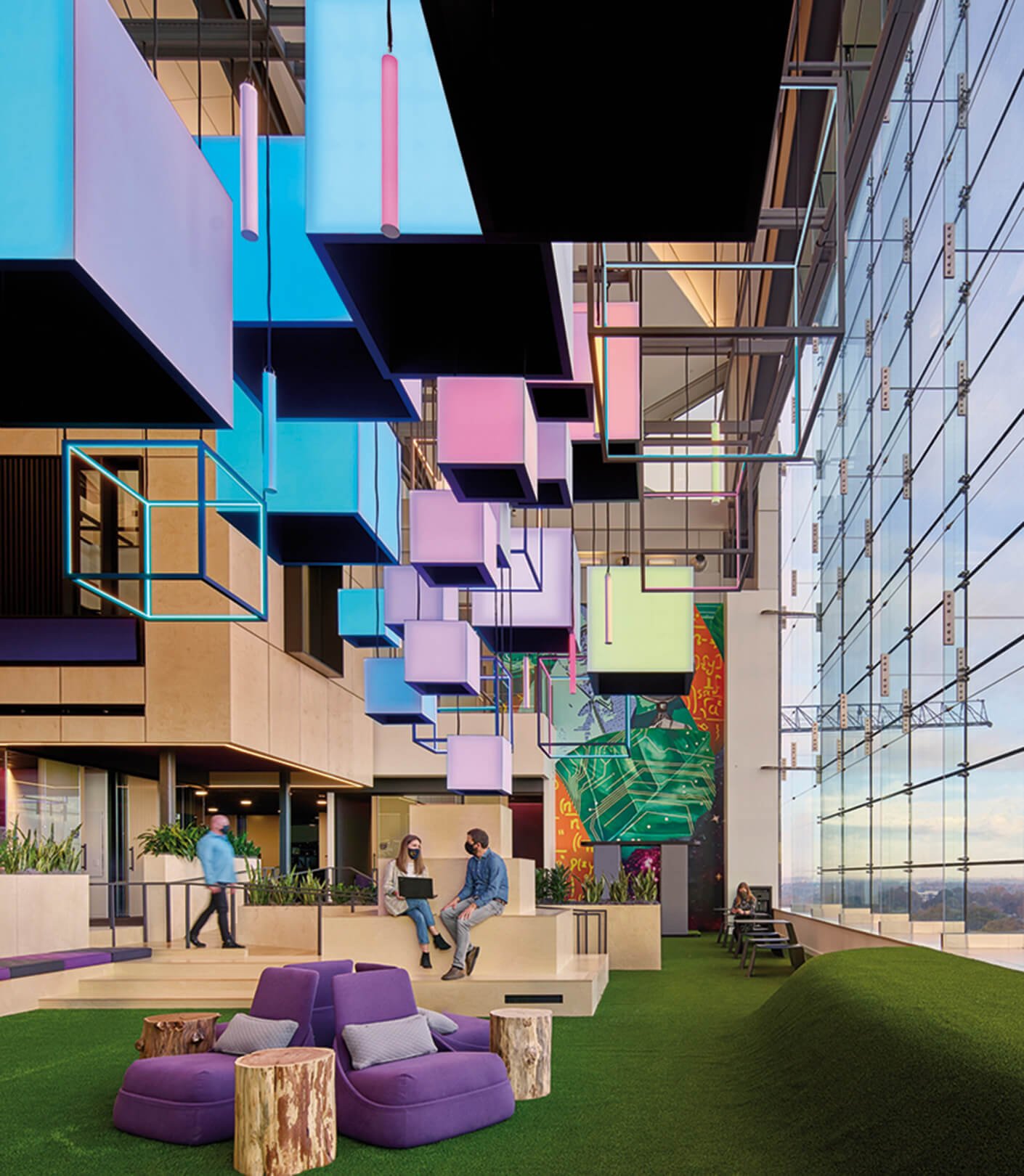 Modern office with colorful geometric ceiling and lounge seating.