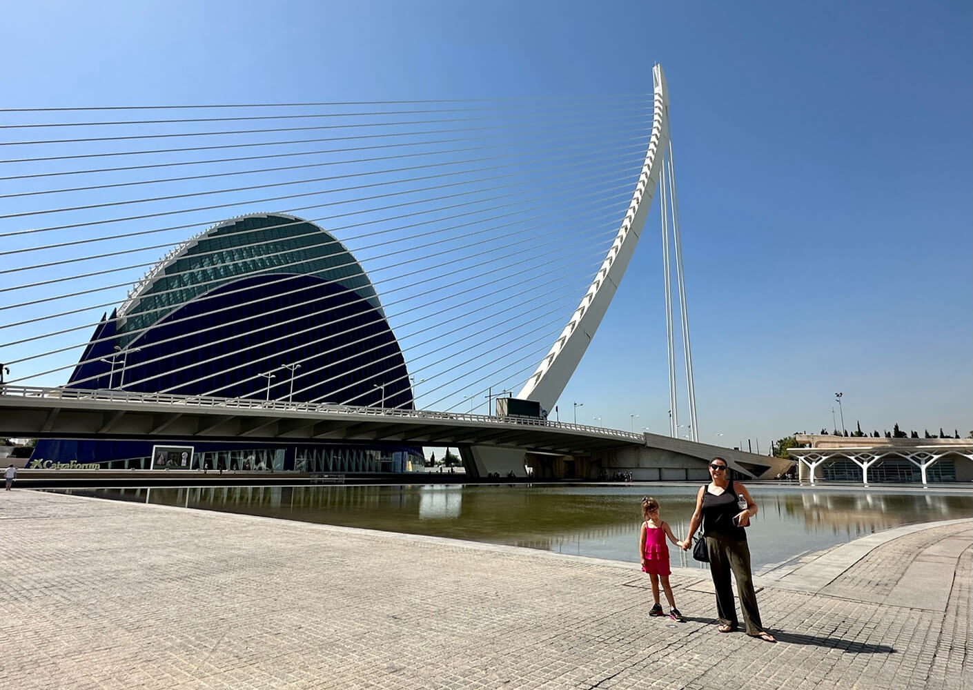 Sophie and her daughter at a waterfront plaza.