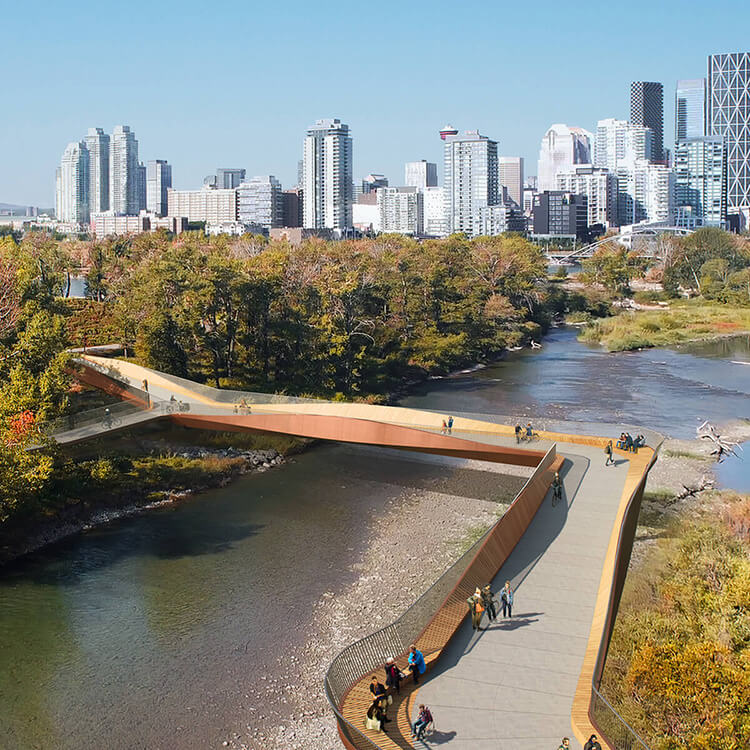 Modern pedestrian bridge over a river with a city skyline in the background.