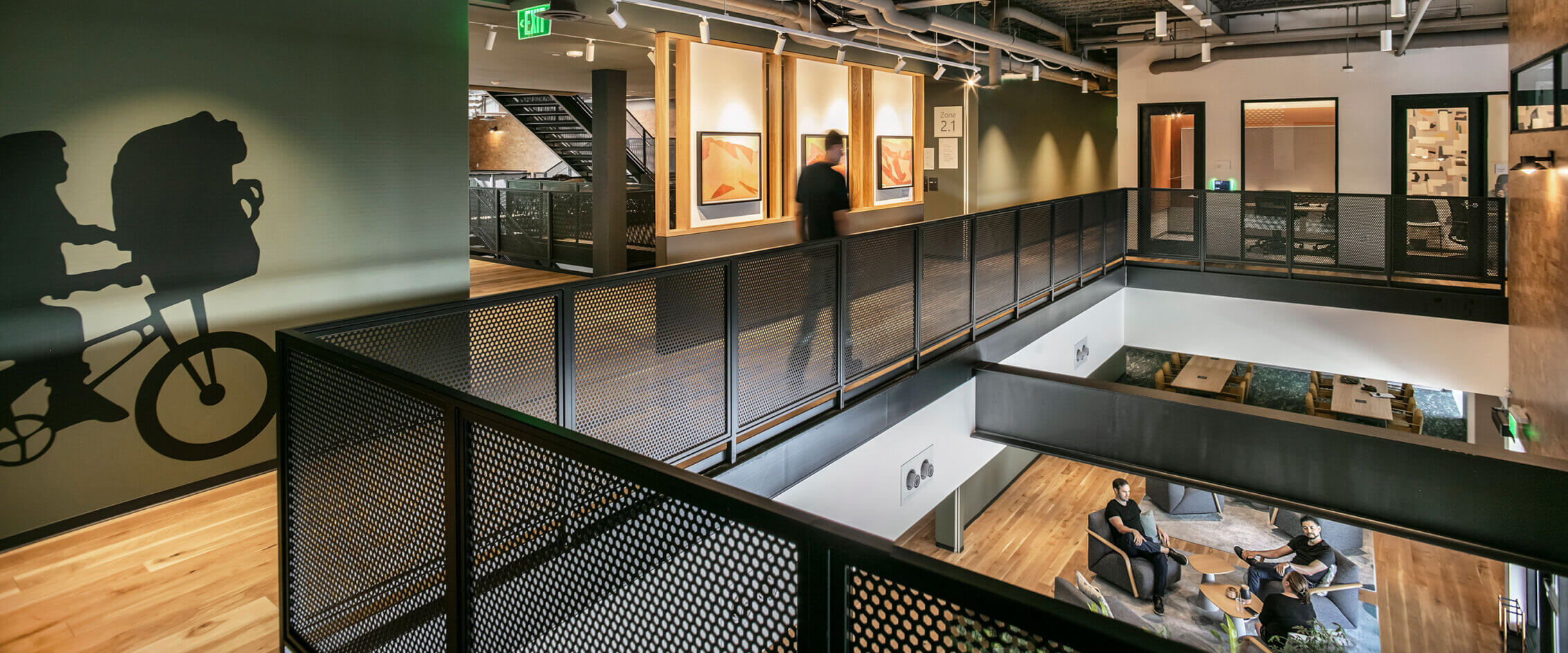 Modern office interior with wall art and open seating area.