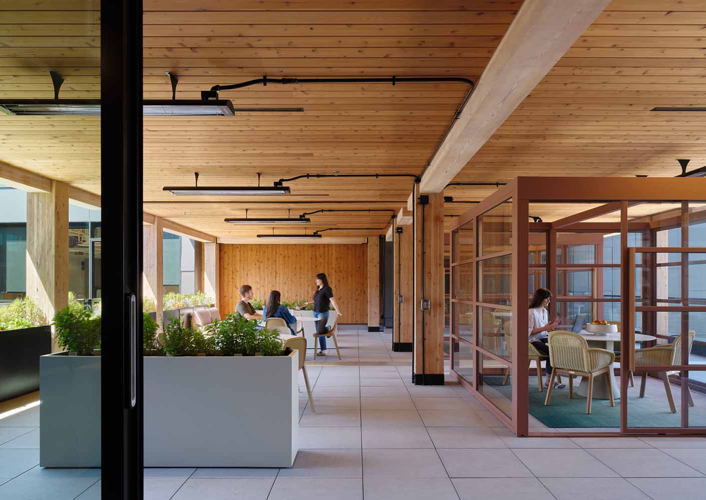 Modern office space with wooden design and team collaboration.