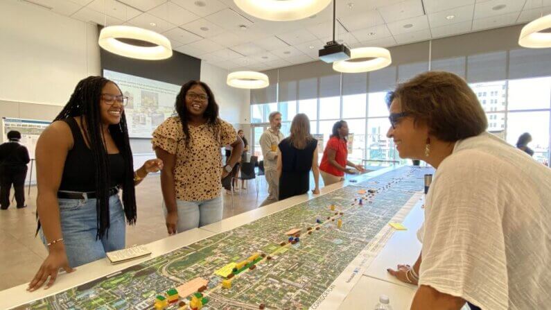 Participants engaging in a community planning discussion around a large map.