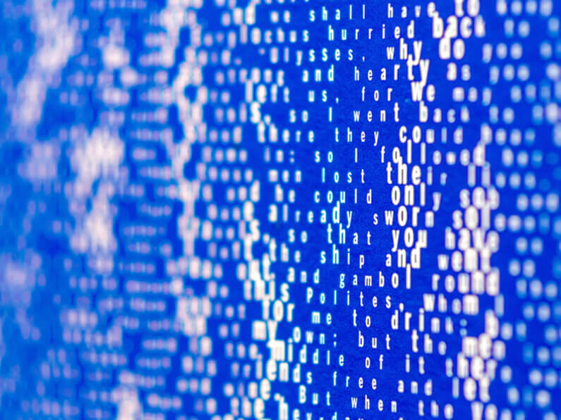 Abstract text on a blue background, creating a visually striking and artistic effect.