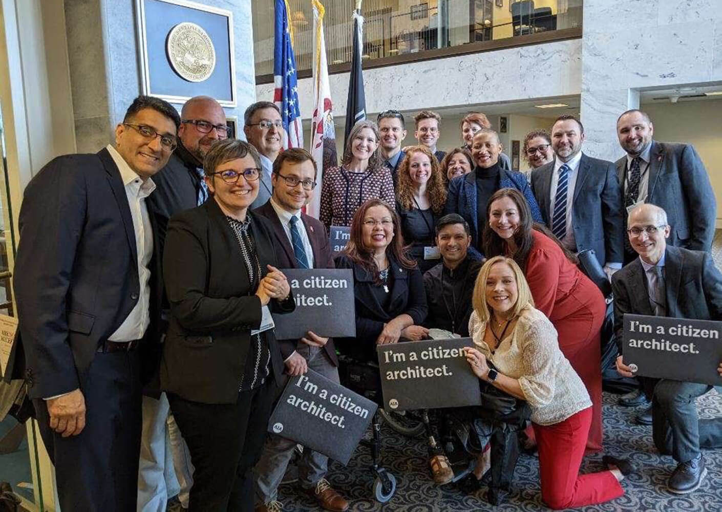 Group photo of architects advocating with I'm a citizen architect signs.