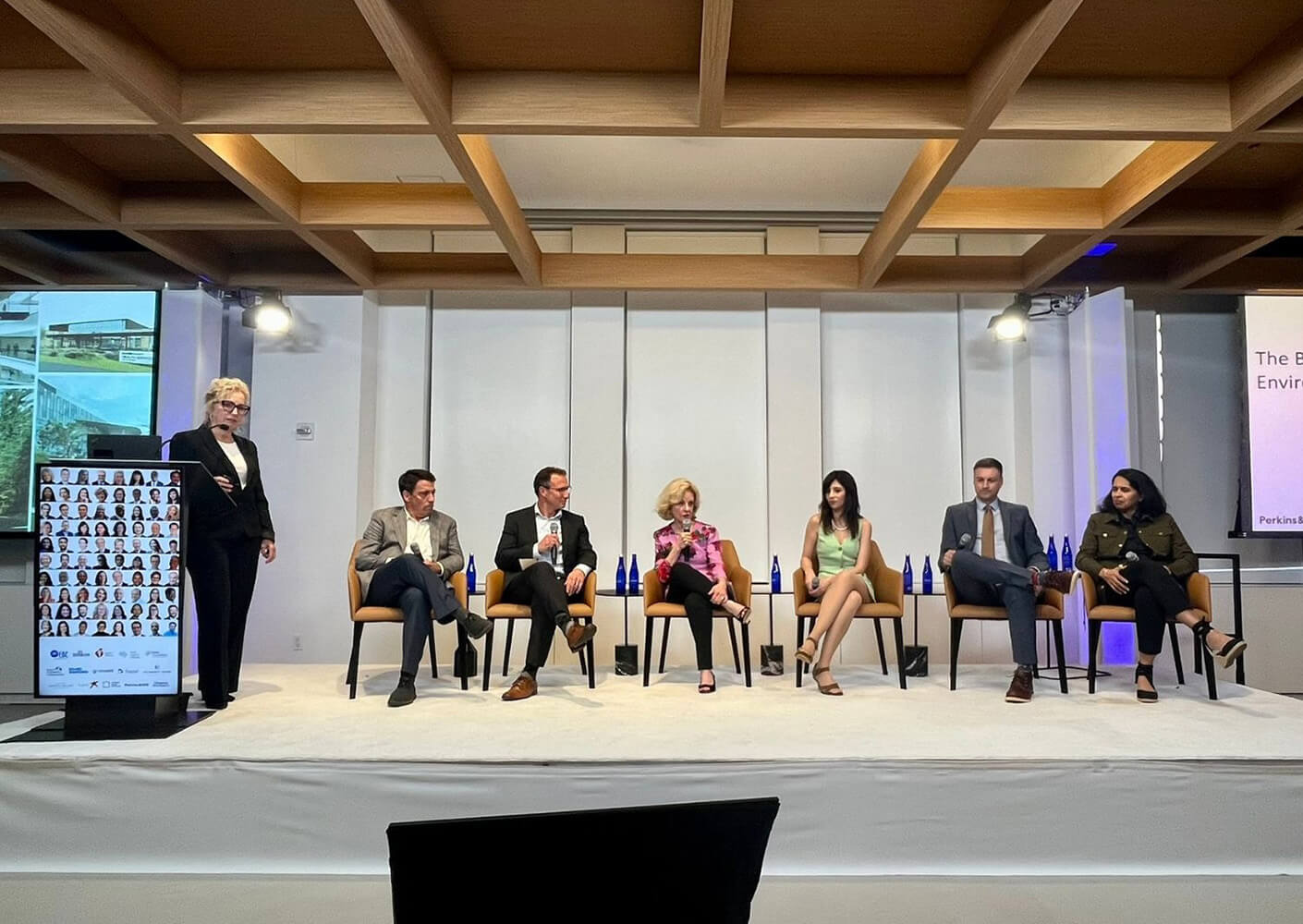 Panel discussion on environmental topics at a conference, featuring six speakers.