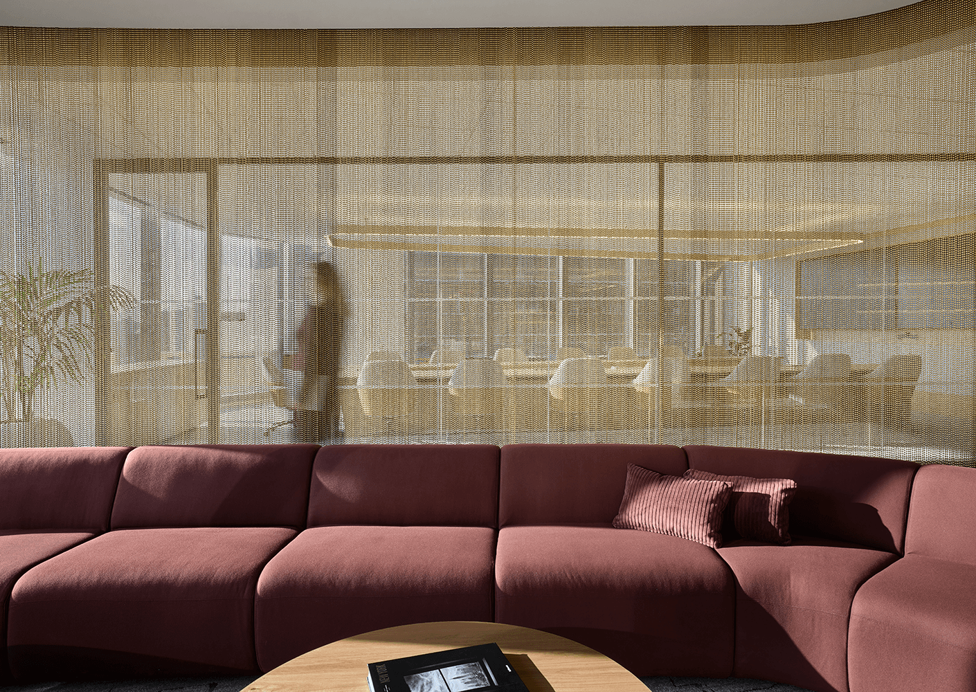 Burgendy couch with beaded wall detail behind