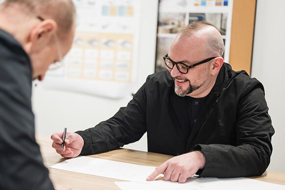 Chris Hardie and another designer collaborating at a desk. 