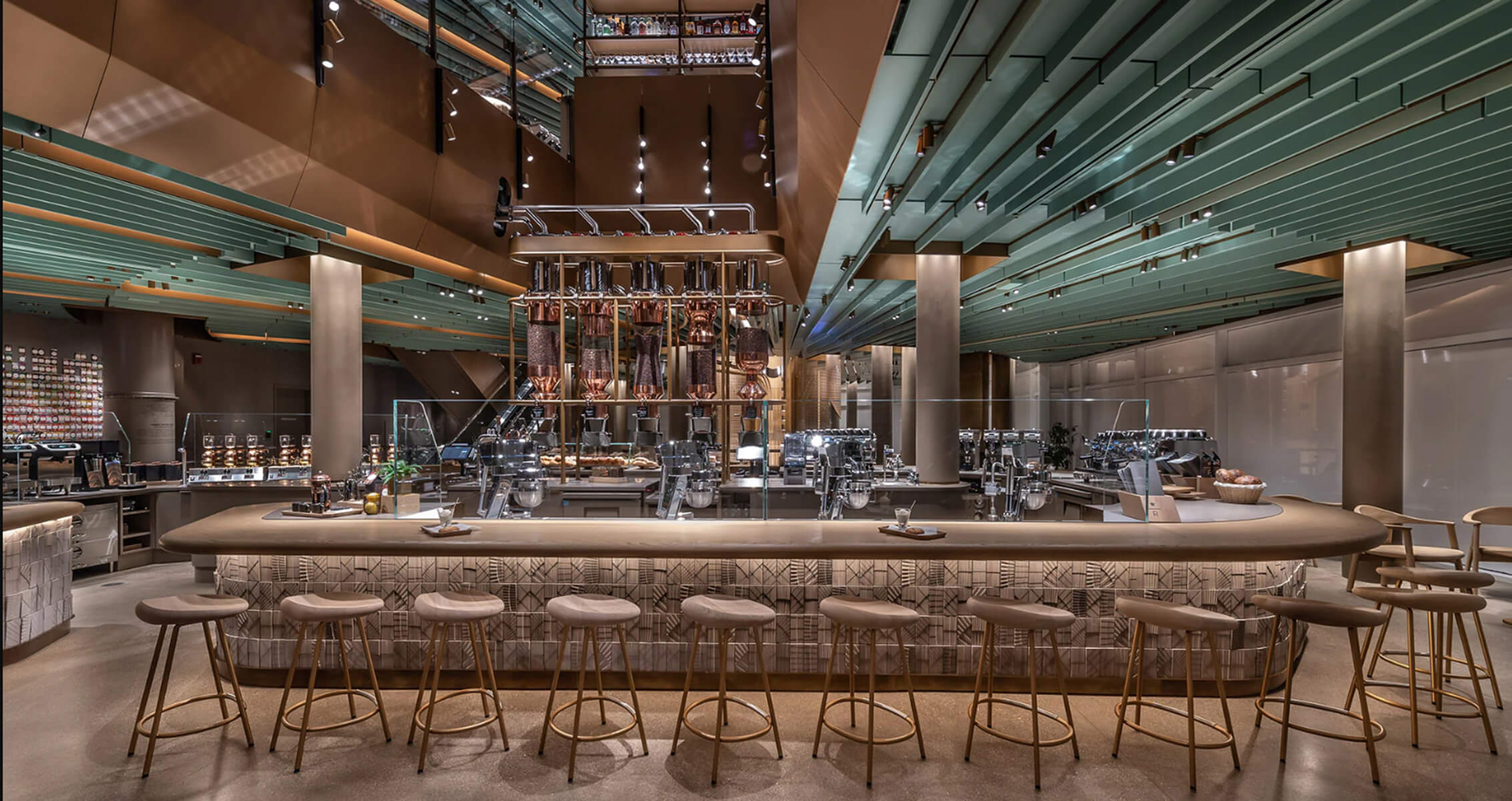 café interior featuring sleek lines, layered ceilings, and a stylish curved bar.