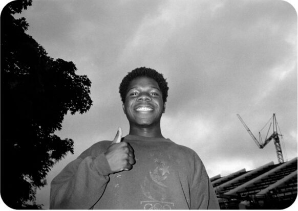 Donald smiling and giving a thumbs-up in black and white film image. 