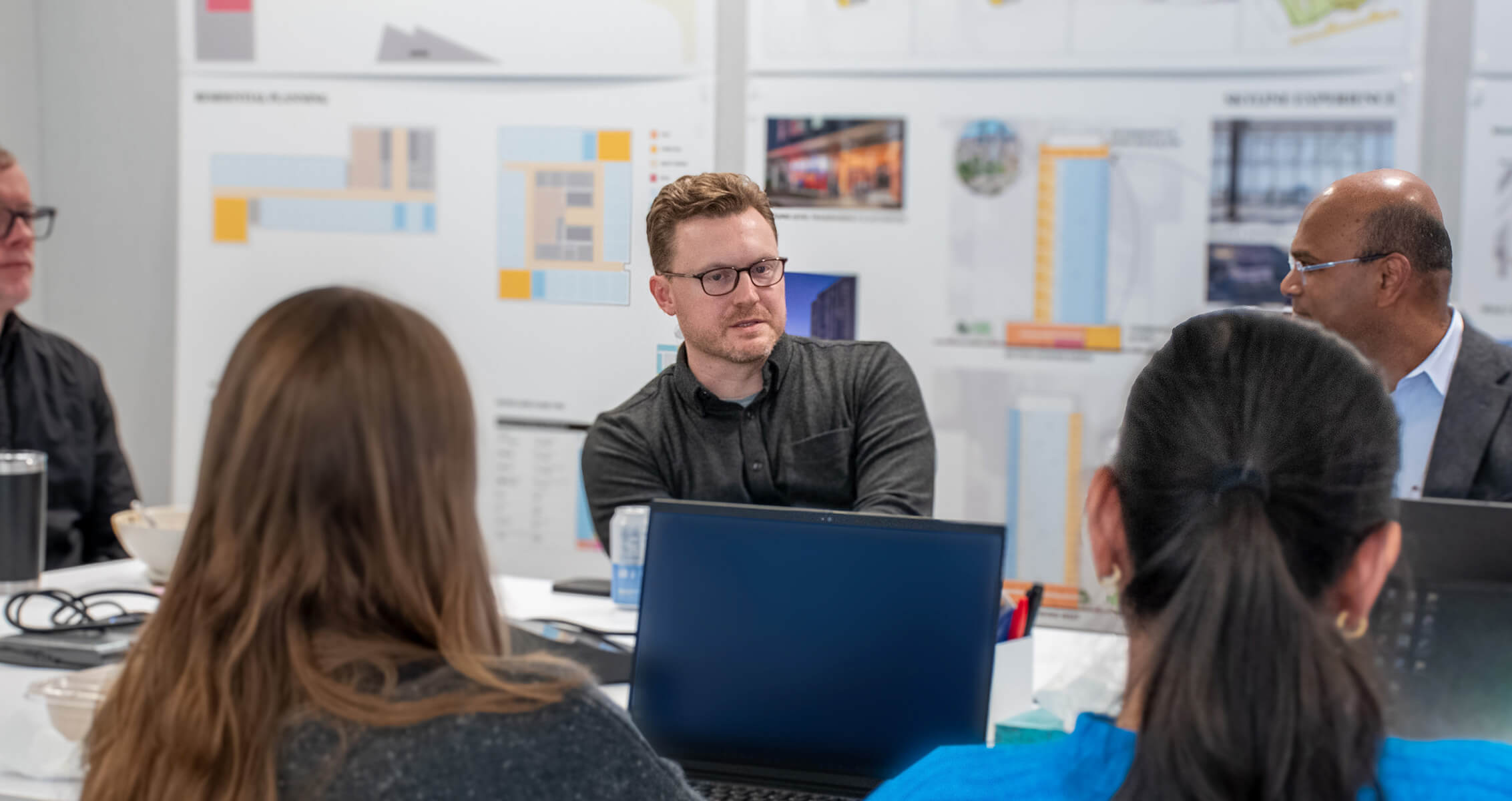 Chris Karlson and teammates engaged in conversation and collaboration.