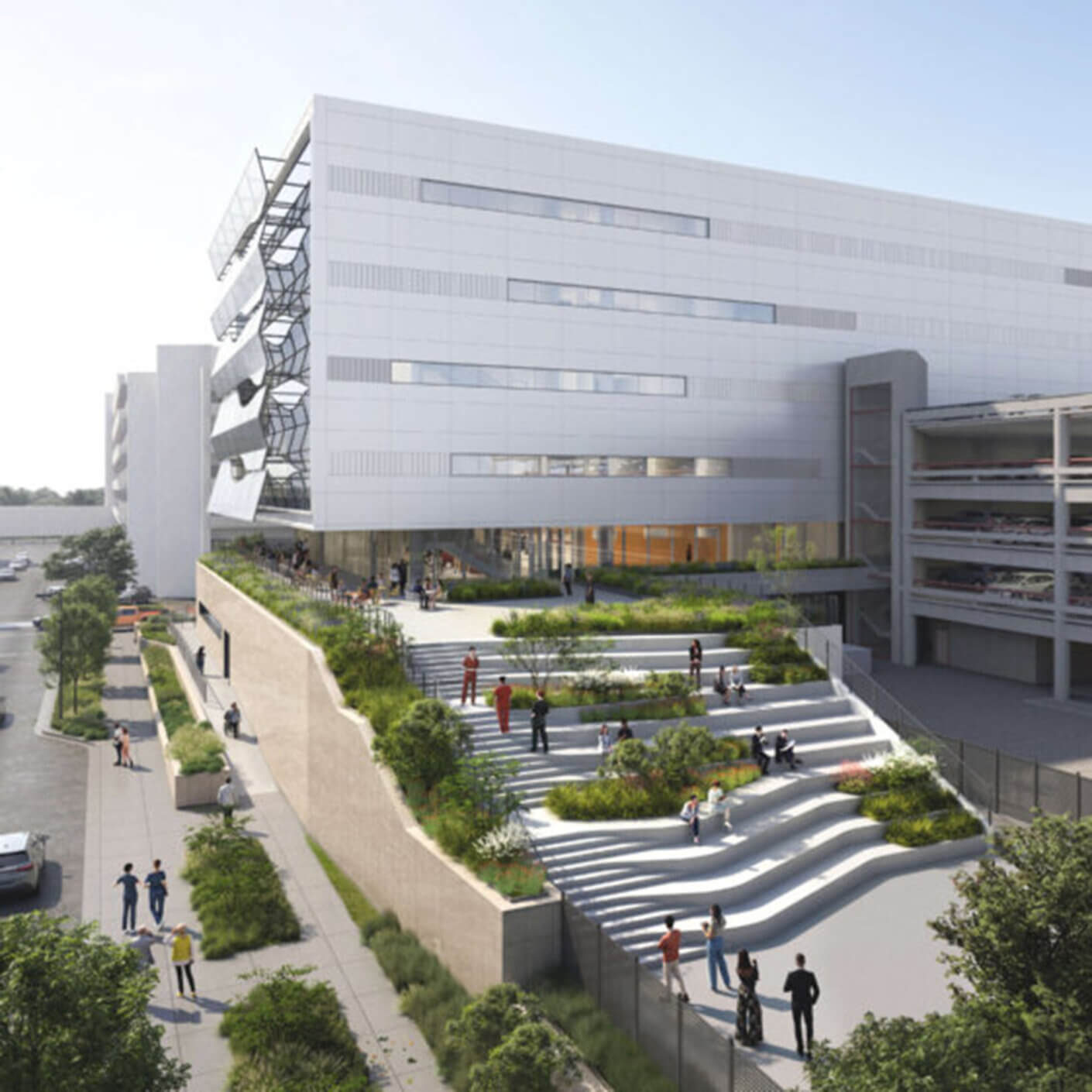 New building with greenery and tiered landscaping, showcasing outdoor spaces and people engaging around the entrance and paths.