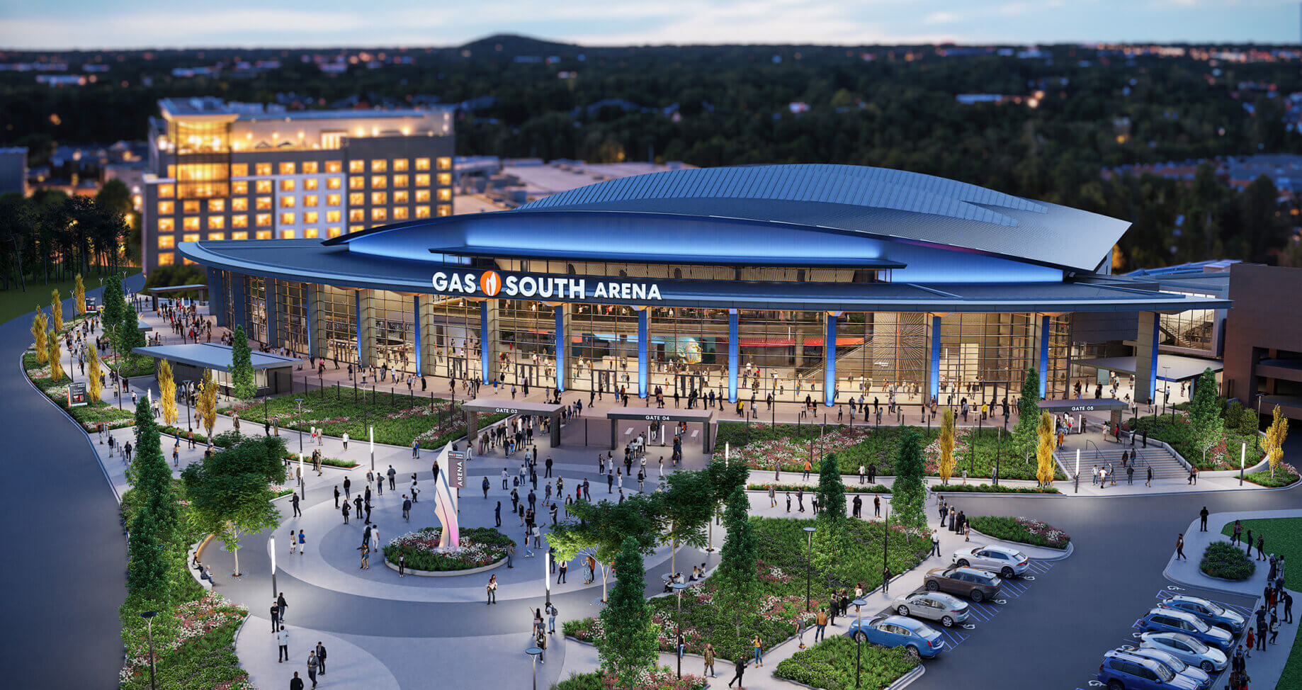 Aerial view of Gas South Arena featuring its entrance, landscaped surroundings, and crowd gathered outside for an event. Evening city skyline visible.