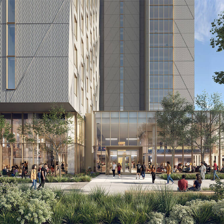 People walk in front of a high-rise building with large glass windows and greenery, featuring outdoor seating areas and a bustling atmosphere.