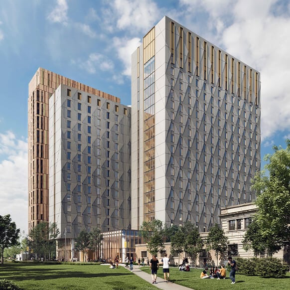 Two tall buildings with geometric facades and wooden accents, surrounded by green space and people enjoying the outdoors.